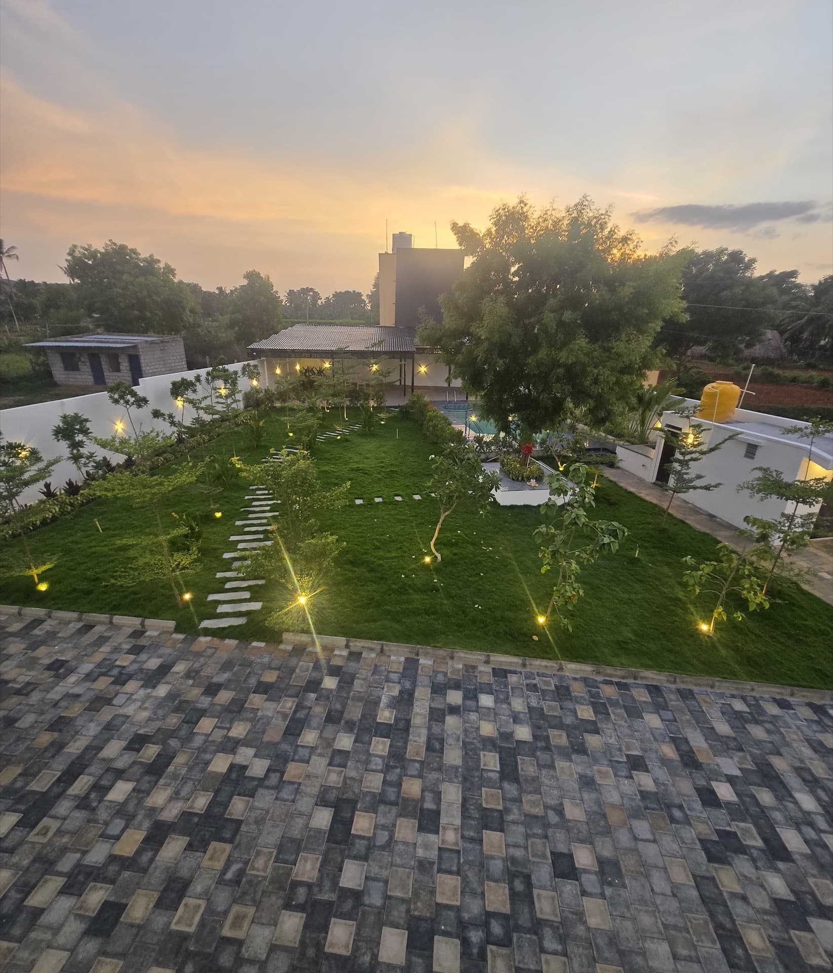 Landscaped lawn and pool aglow at golden hour