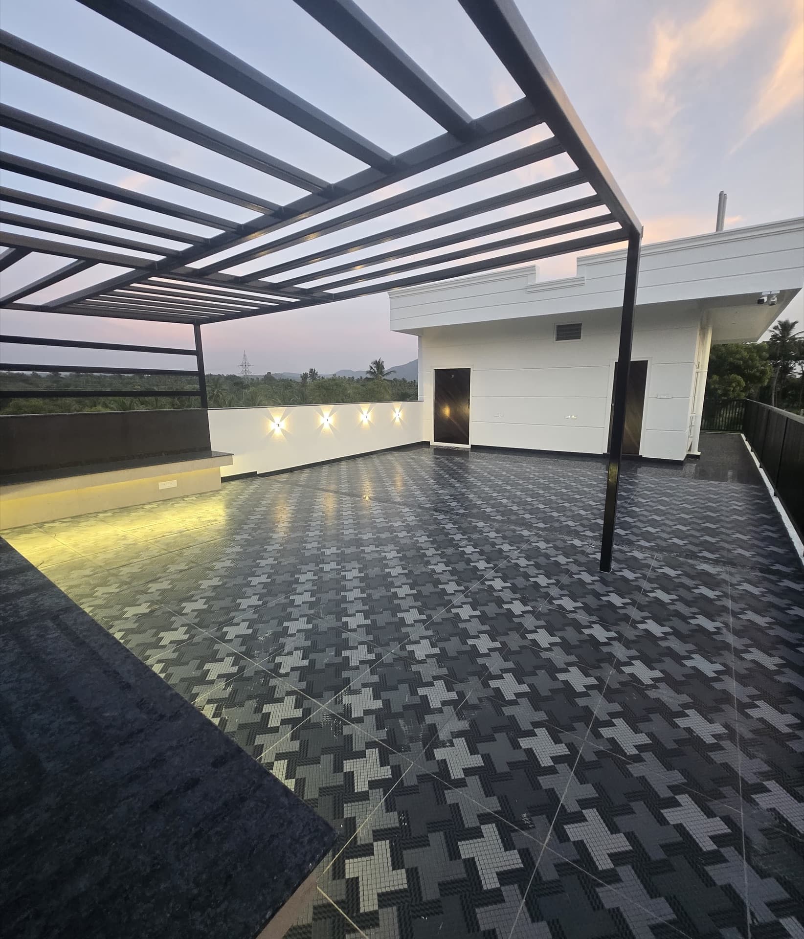 Rooftop pergola terrace with patterned tiling at dusk